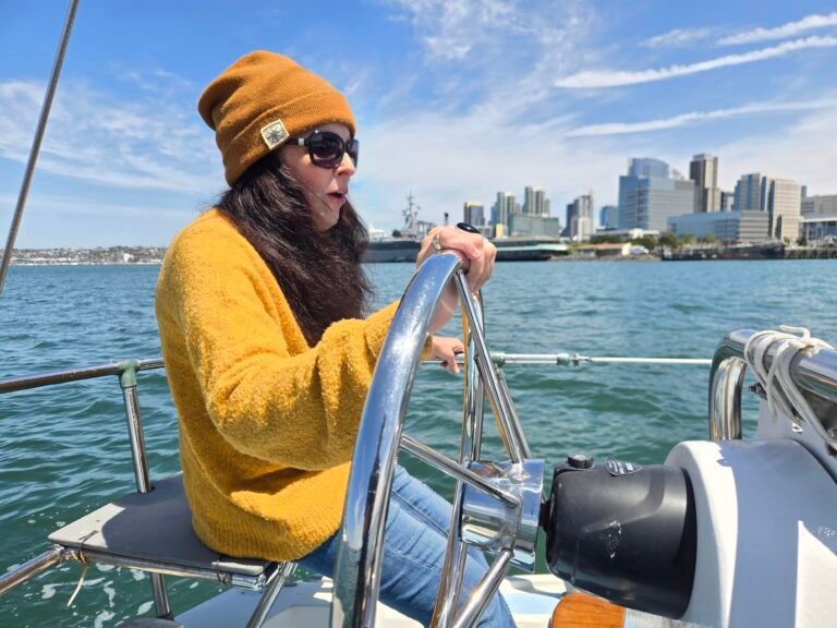Author Teri Siri at the wheel of Wolf on San Diego Bay