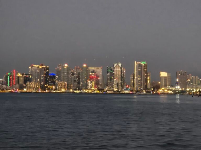 Downtown San Diego lighting up at sunset, seen from the bay